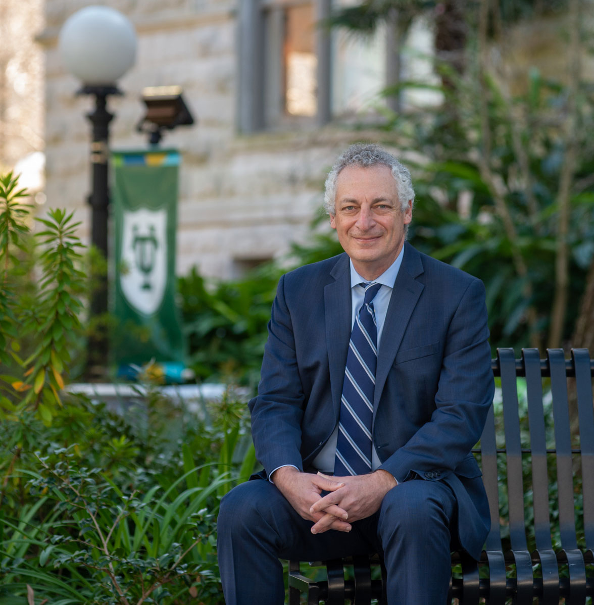 Provost Robin Forman seated on campus bench