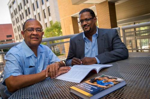 Cunningham and Barbarin seated at outdoor table on campus